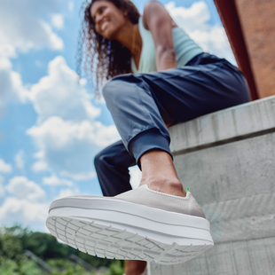 model sitting on ledge wearing oomega eeZee nomad